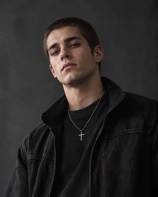Young man with a fresh buzz cut in a dark jacket