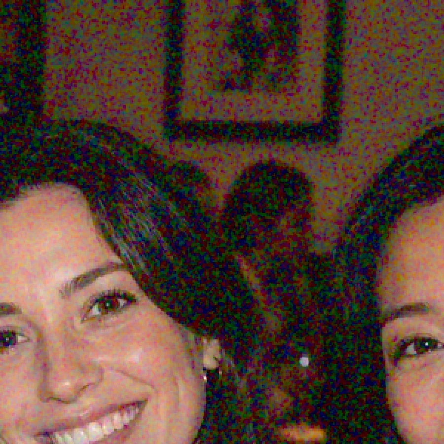 The same crop with color noise: red, green and purple blotches across the wall and faces