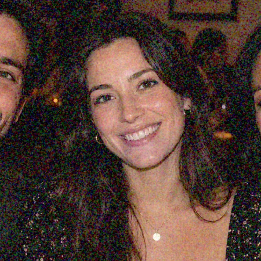 The same dim photo brightened in an editor, now grainy with speckles across faces and background