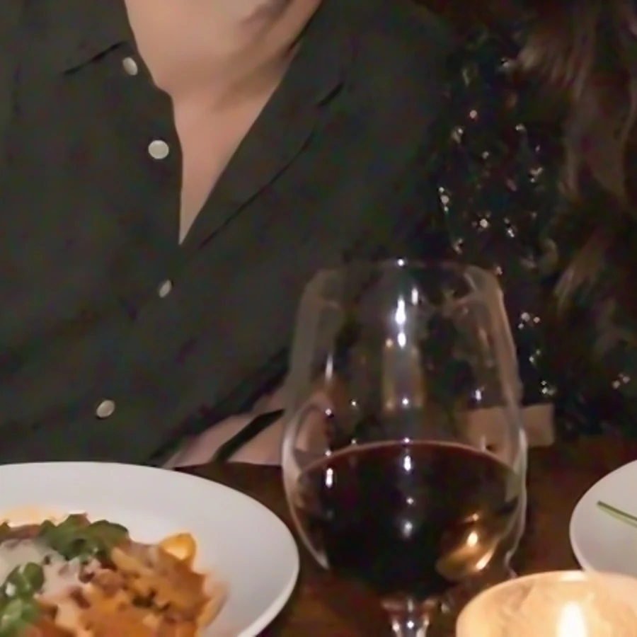 The dinner photo after noise reduction, with a clean shirt and table and the glass and food still detailed