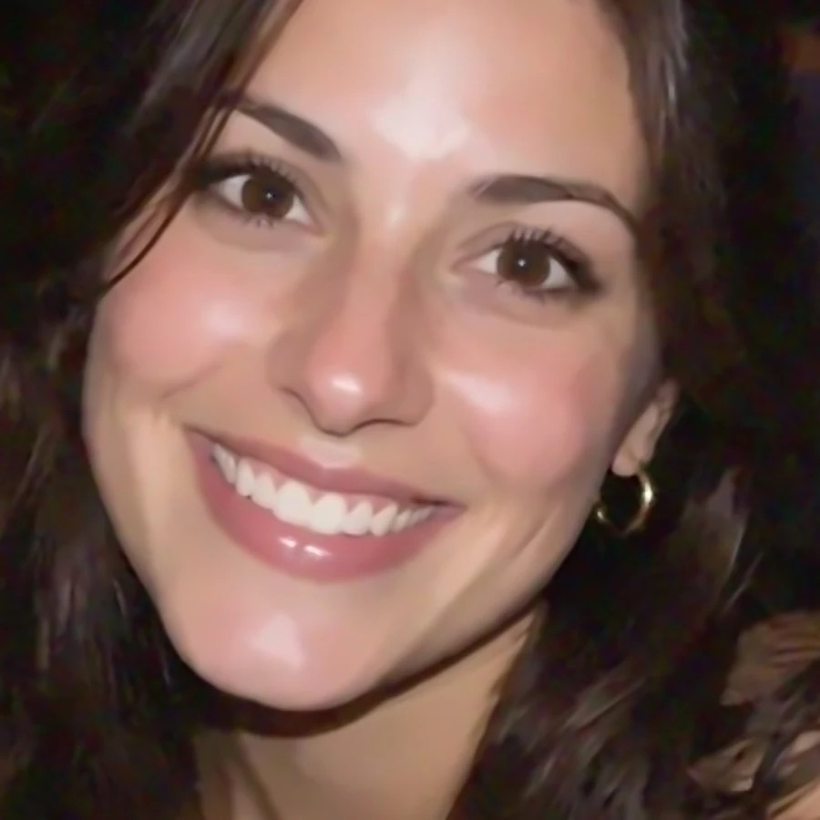 The same grainy portrait with balanced noise reduction, clean but with sharp eyes and natural hair