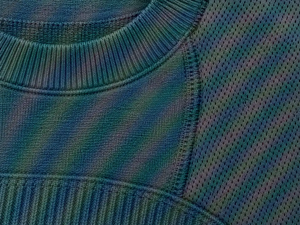 Moire Lightroom example: rainbow color moire bands across a teal knit sweater