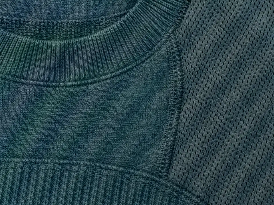 The knit sweater with its color moire smoothed, showing what Lightroom moire reduction targets, with faint gray ripples left