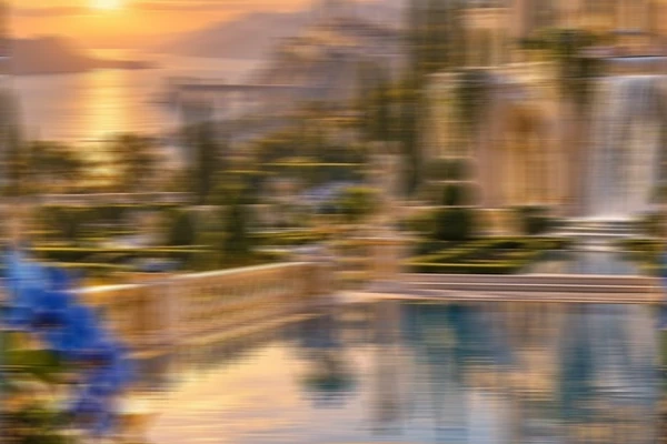 Simulated horizontal motion blur smearing a palace garden scene