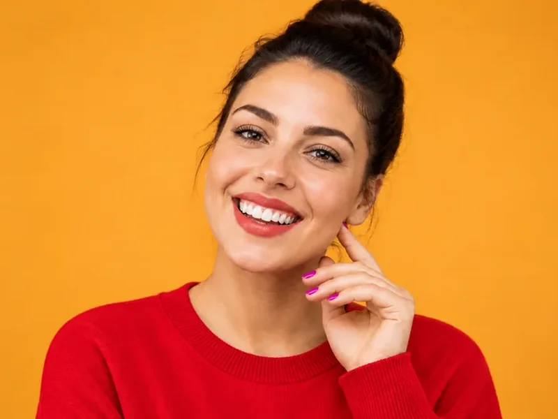 Drag to compare a blue sweater with the same woman wearing a red sweater (after)