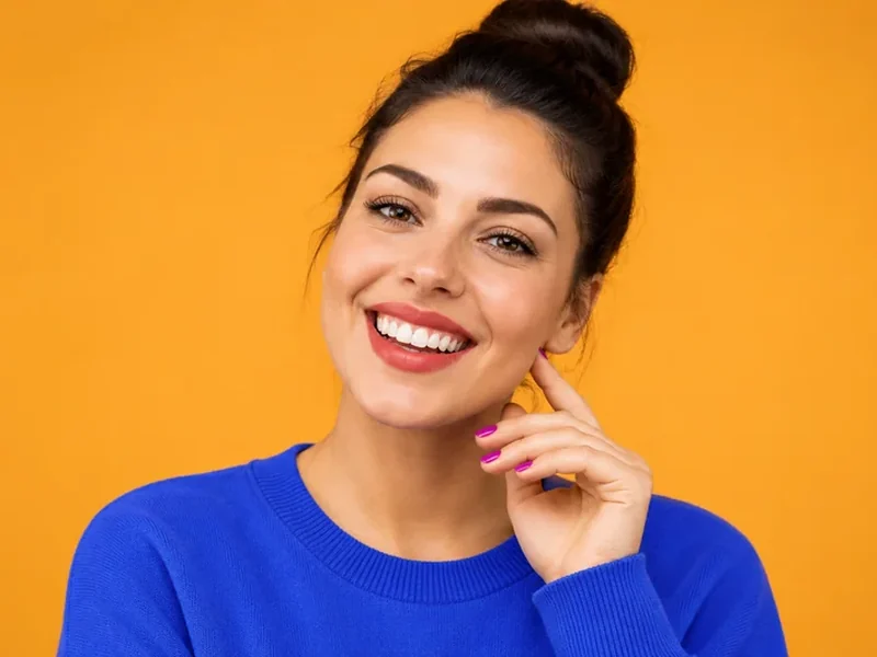 Drag to compare a blue sweater with the same woman wearing a red sweater (before)