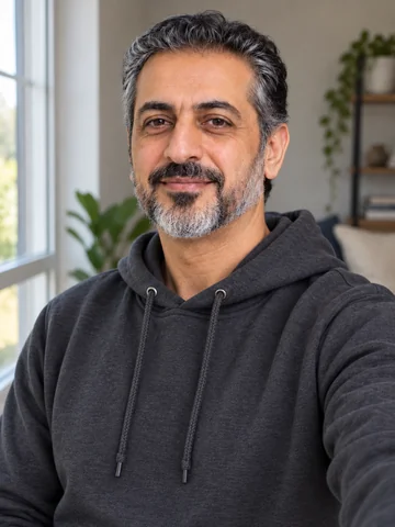 Drag to compare a casual hoodie selfie with the AI doctor headshot in a white coat (before)