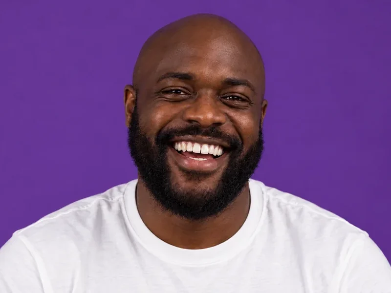 Drag to compare a smiling man before and after natural teeth whitening (after)