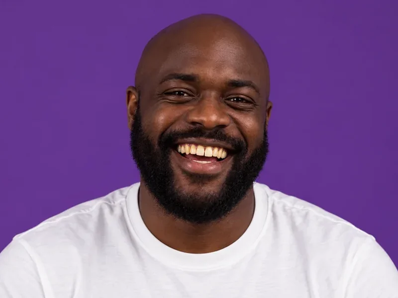 Drag to compare a smiling man before and after natural teeth whitening (before)