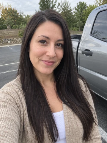 Drag to compare an outdoor photo with the AI corporate headshot in a beige blazer (before)