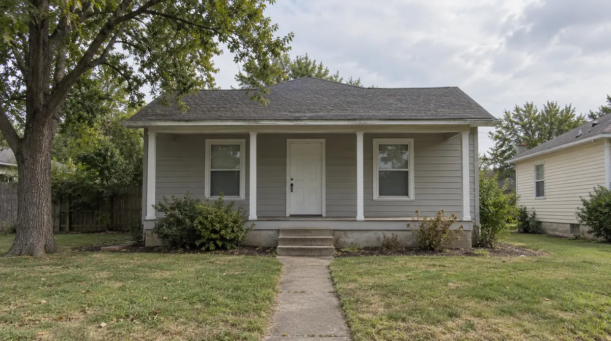 Drag to compare the gray bungalow and the craftsman-style remodel (before)