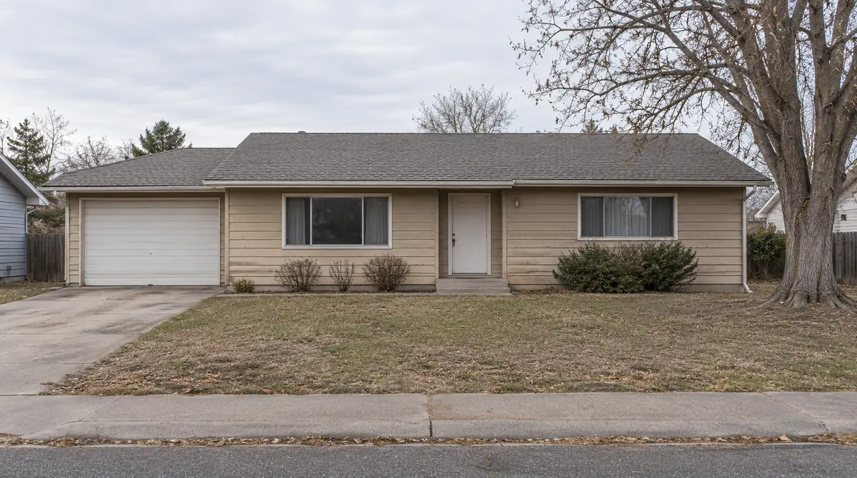 Drag to compare the dated ranch house and its modern farmhouse remodel (before)