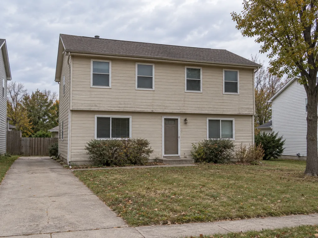 Drag to compare a plain beige house and the same house in a mid-century wood exterior (before)
