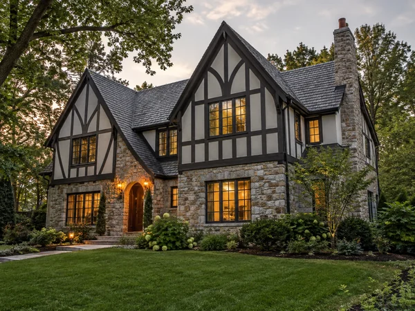 Tudor house with half-timbered gables and a stone lower wall