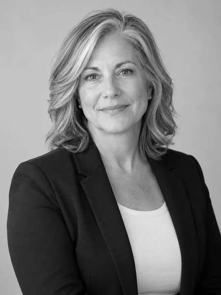 Black and white nursing headshot of a woman in scrubs