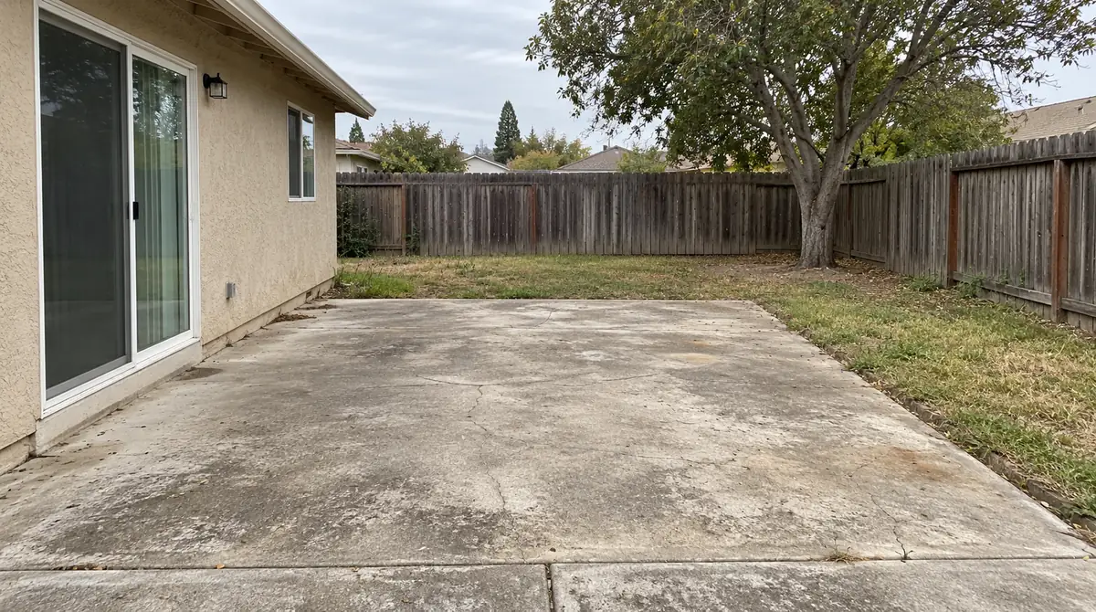 Drag to compare the bare concrete patio and its modern redesign (before)