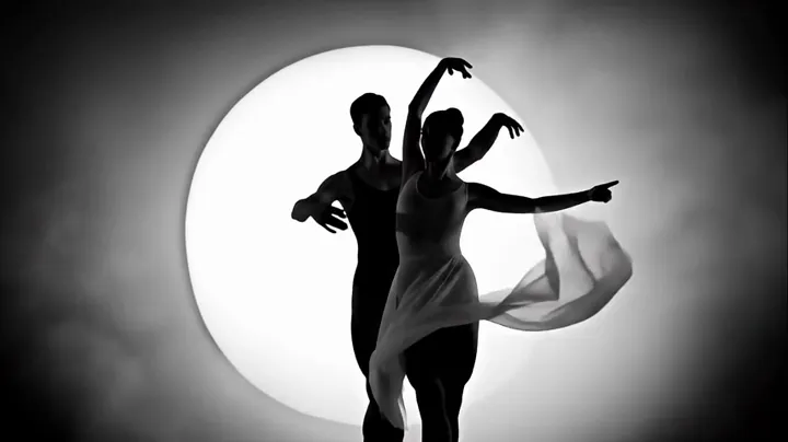 Frame from the extended part of the clip: two silhouetted dancers in front of a glowing moon