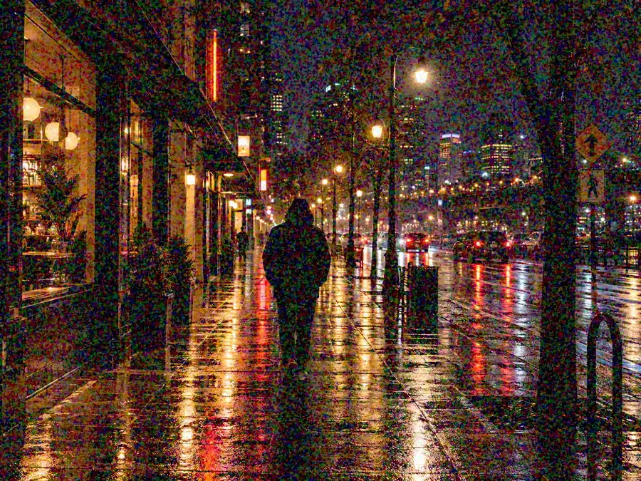 Drag to compare the grainy night street photo and the denoised street (before)