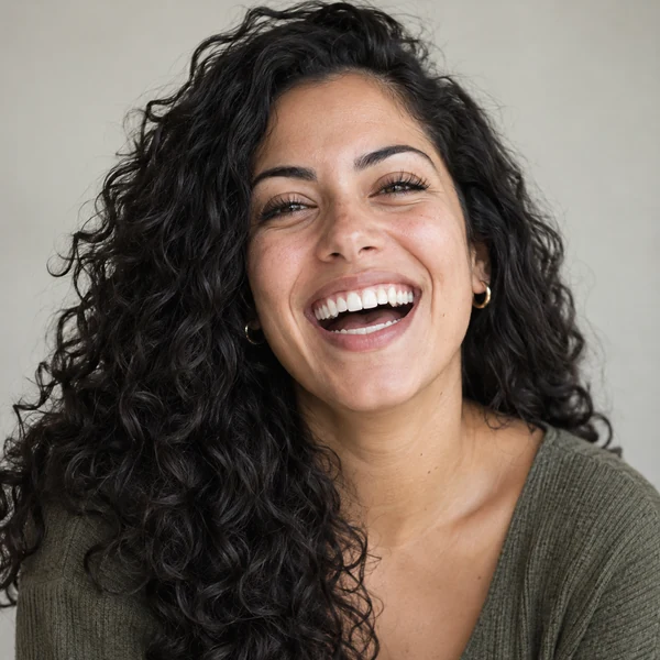 Woman laughing with an open mouth and crinkled eyes