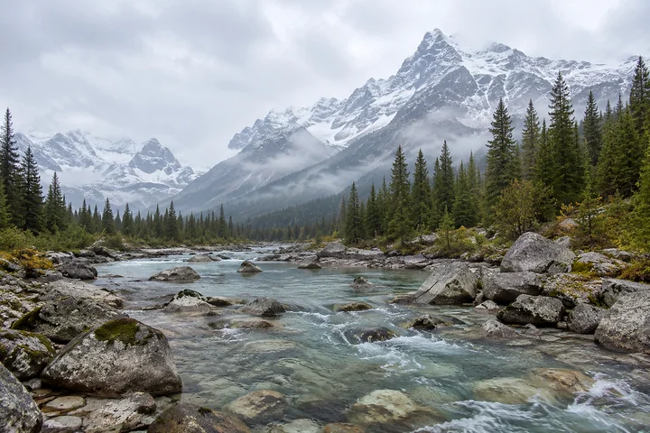 Drag to compare the flat mountain stream photo and the AI HDR landscape version (after)