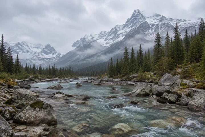 Drag to compare the flat mountain stream photo and the AI HDR landscape version (before)