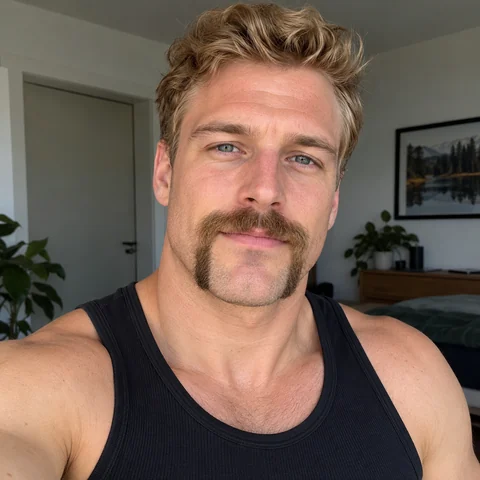 Man with wavy blond hair and a horseshoe mustache