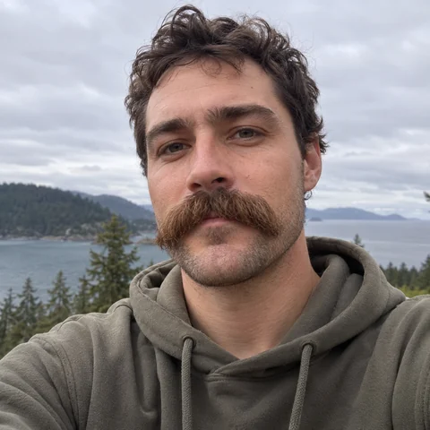 Man in a hoodie with a thick, drooping walrus mustache