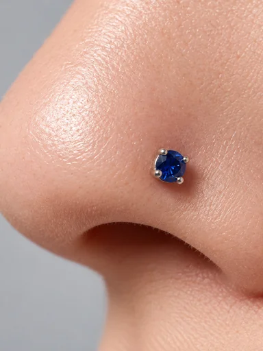 Close-up of a blue gem stud on a nostril