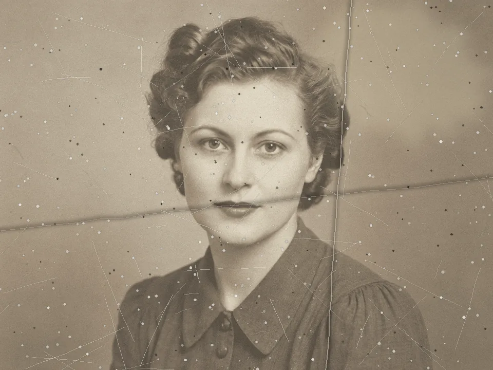 Drag to compare the scratched, creased sepia portrait and the restored print (before)