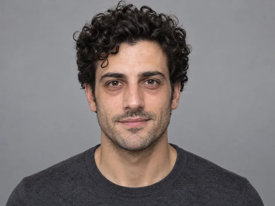 Drag to compare the curly-haired man with dark under-eye circles and the rested, retouched portrait (before)