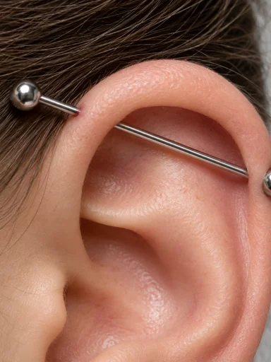Close-up of an industrial barbell across the upper ear