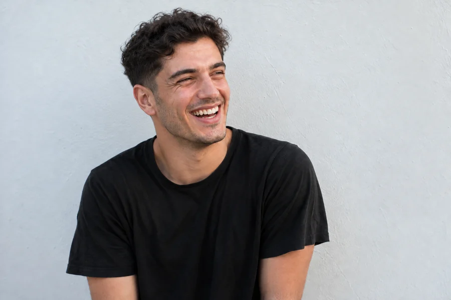 Drag to compare curly hair with the same young man after a short buzz cut (after)