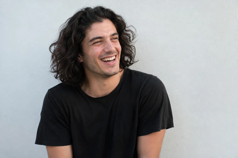 Drag to compare curly hair with the same young man after a short buzz cut (before)