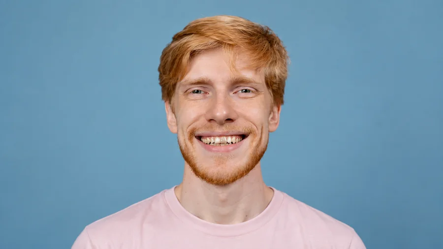 Drag to compare a studio portrait before and after adjusting whitening strength (before)