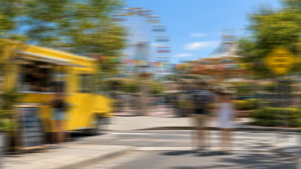 Drag to compare the street photo with strong motion blur and the unblurred image (before)