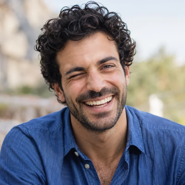 Young man with a laughing wink made by the AI wink filter